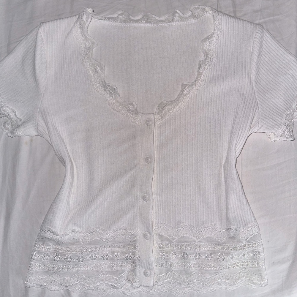 lace v cut neck top with lace at the bottom and the sleeves. cute and coquette.